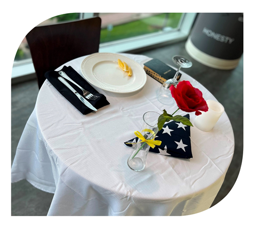 image of table setting with folded flag and rose